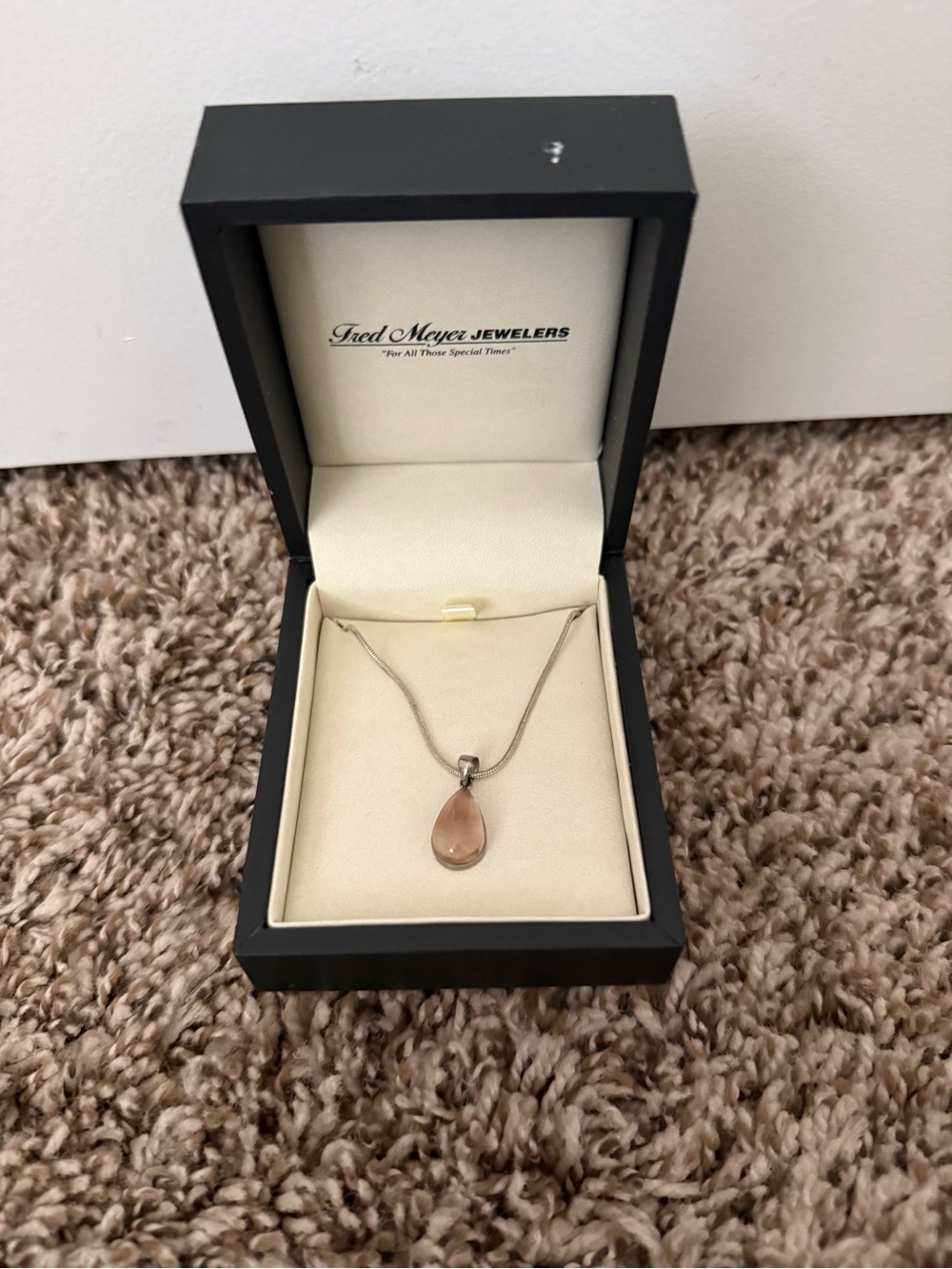 silver necklace with pink teardrop pendent